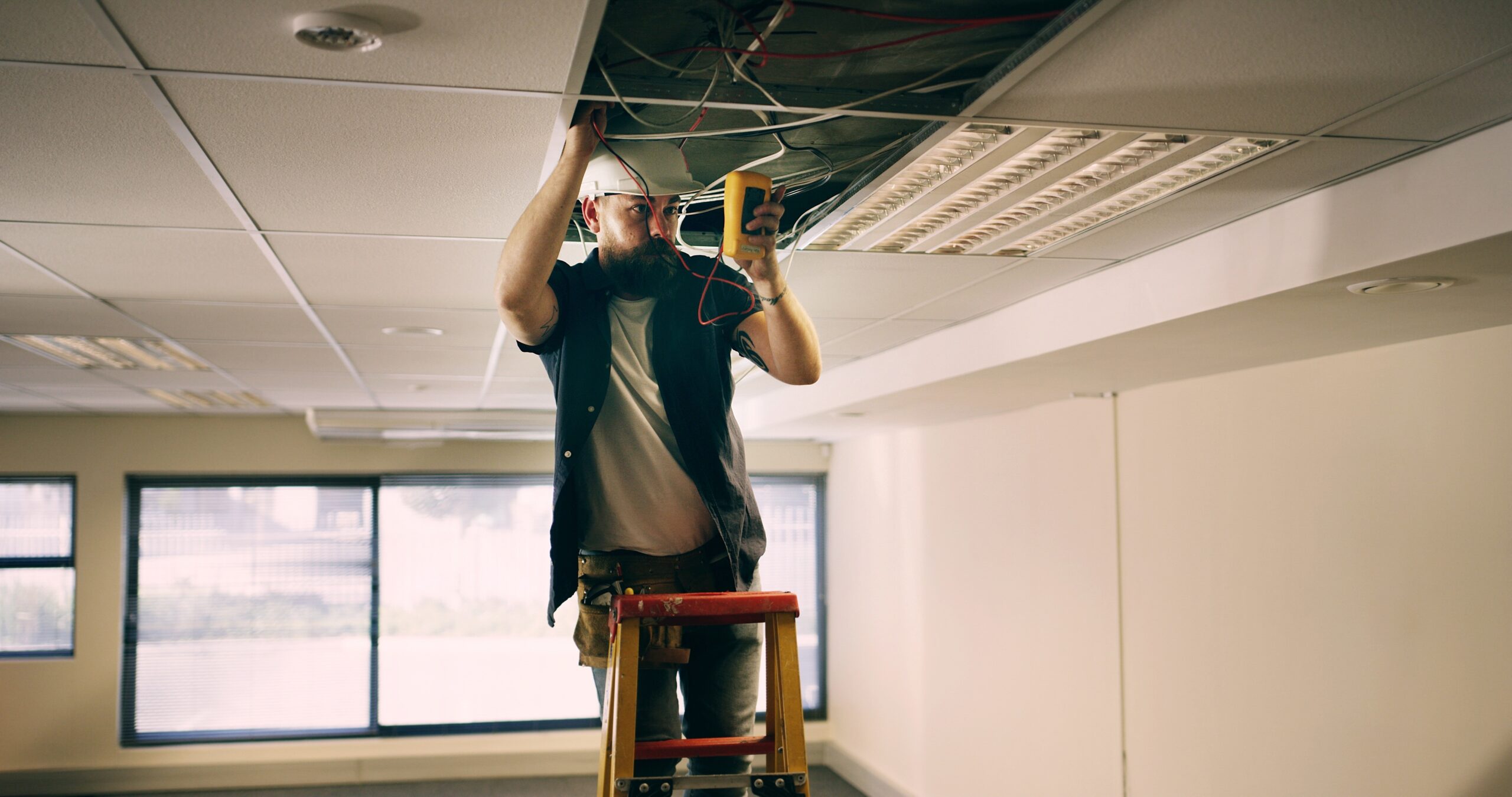 homeowner reviewing what to check before you call an electrician near an electrical panel