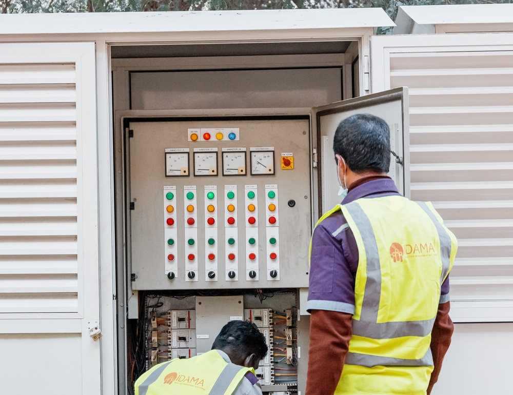 Licensed electrician conducting an electrical system inspection in a residential home panel box